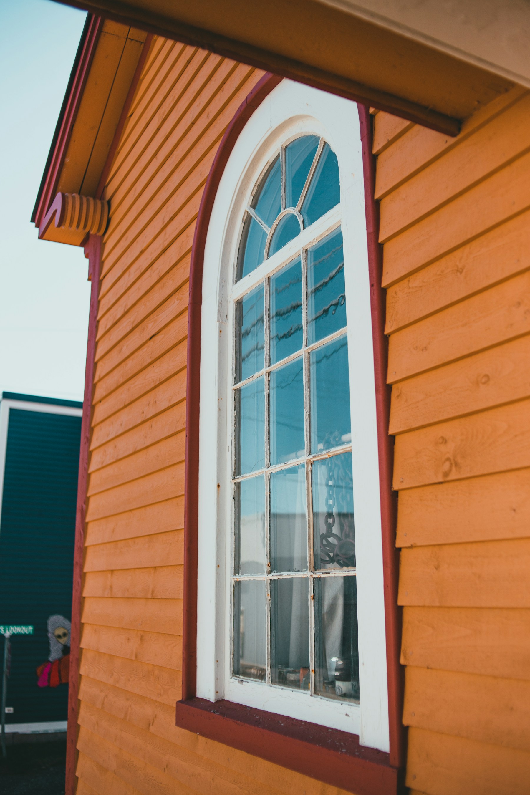 Wood siding with arched window trim